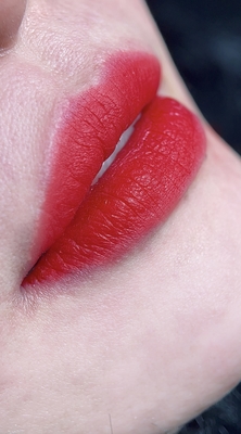 a close up of a woman's lips with bright red lipstick