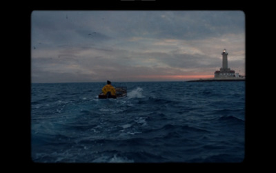 a person in a small boat in the middle of the ocean