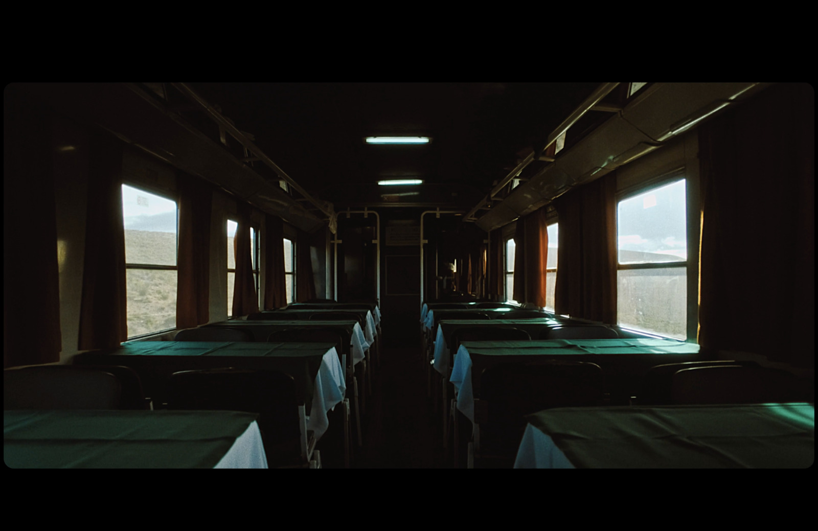 a dining car on a train with tables and chairs