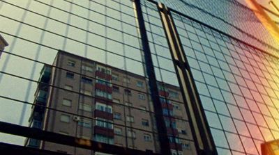 a view of a building through a fence