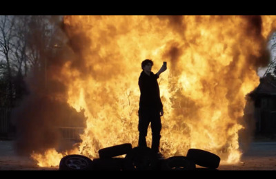 a person standing in front of a large fire