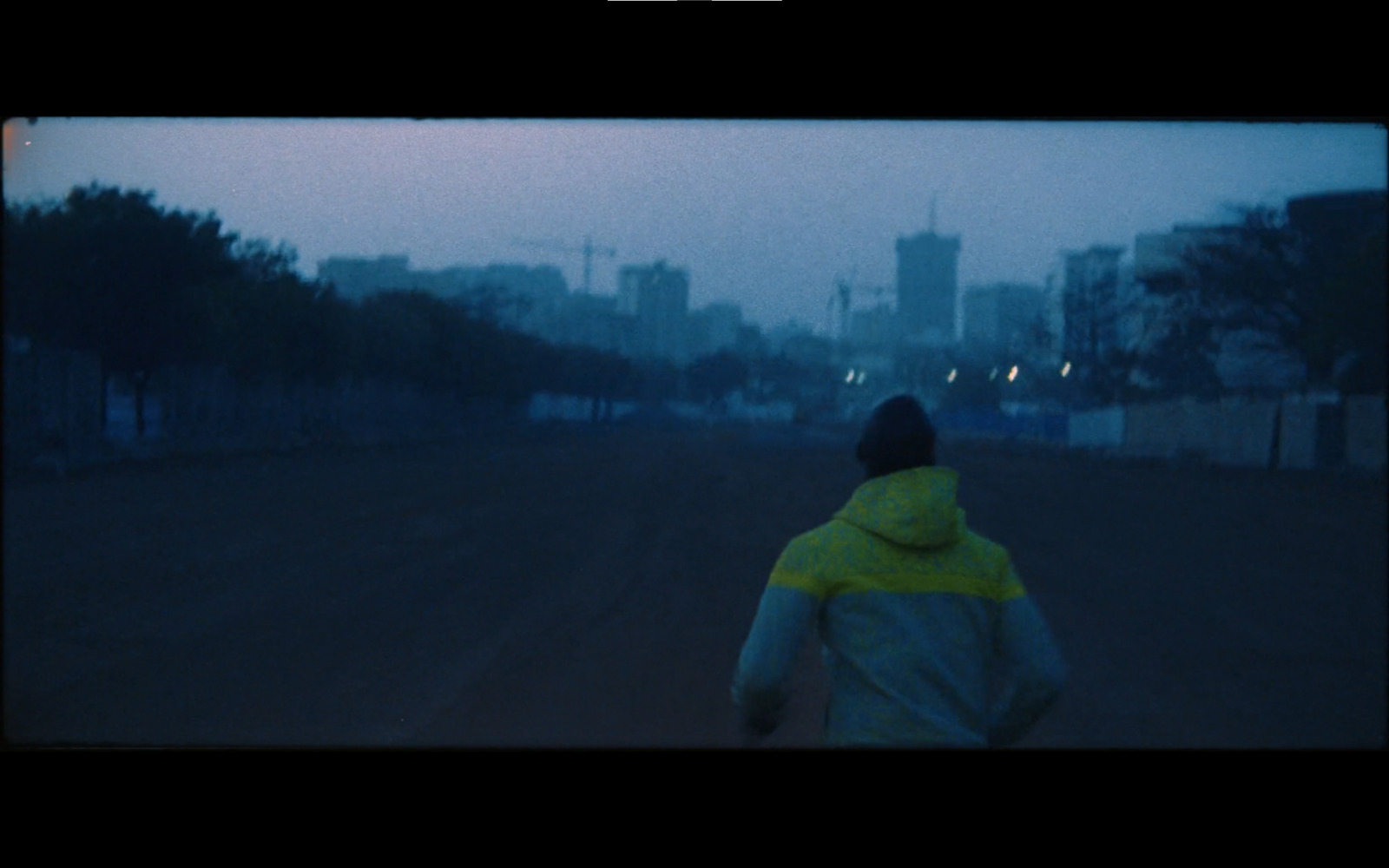 a person walking down a street in the rain