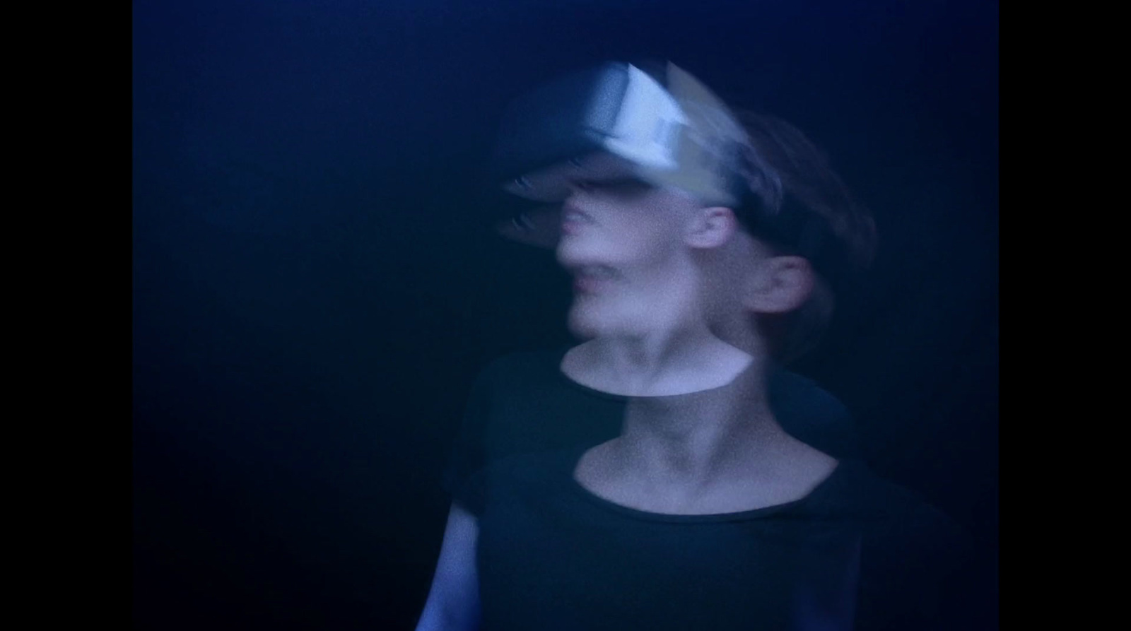 a blurry image of a woman wearing a hat