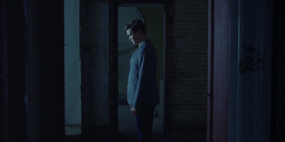 a man standing in a doorway at night