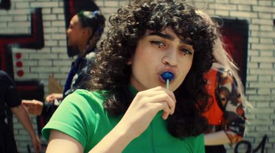 a woman brushing her teeth with a toothbrush