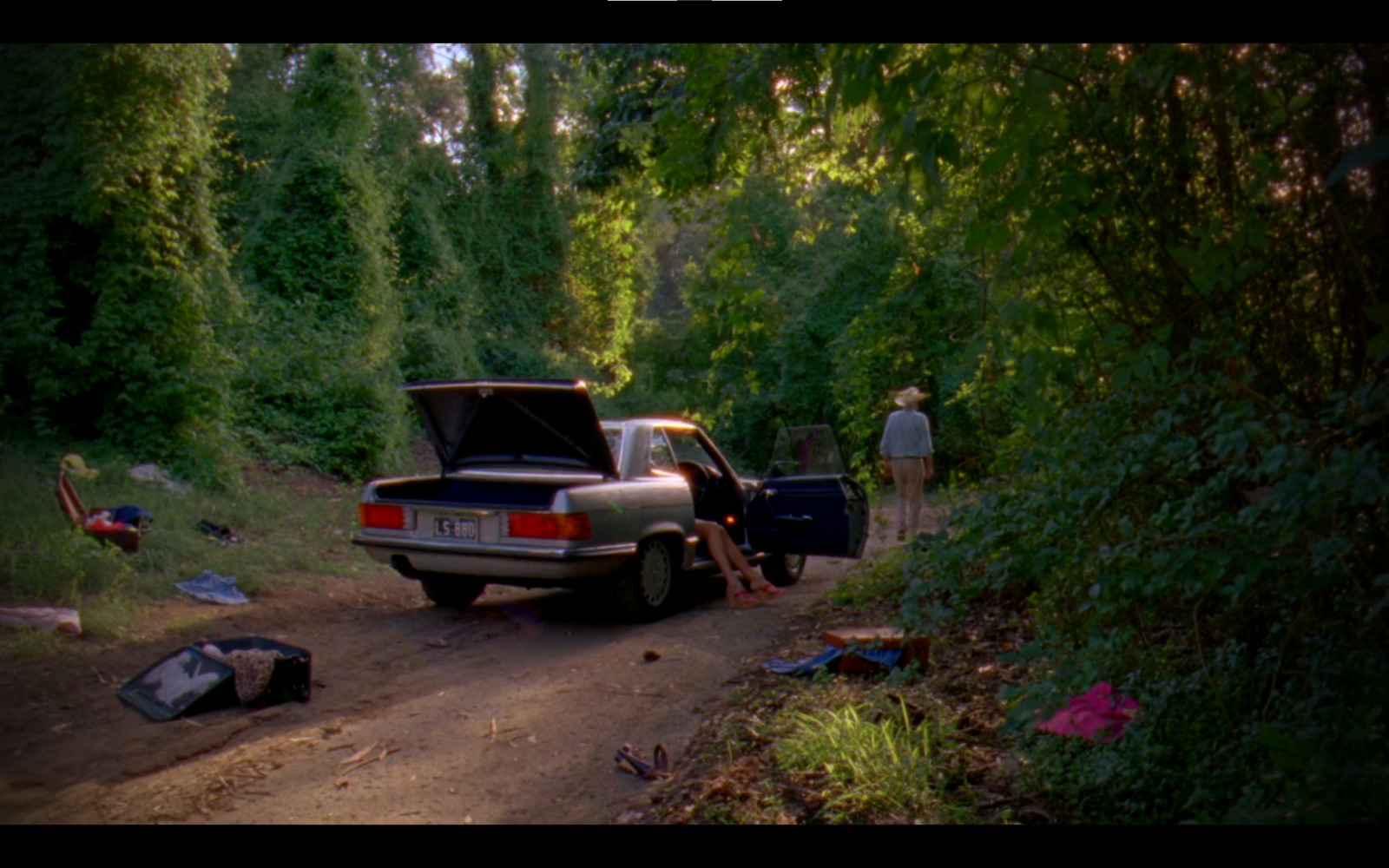 a car parked on the side of a dirt road