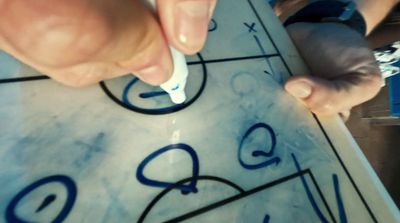 a close up of a person writing on a piece of paper