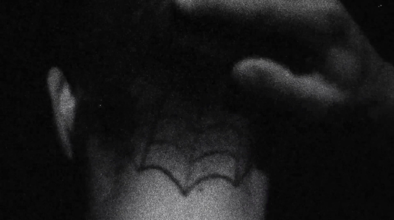 a black and white photo of a person's face with a bat drawn on