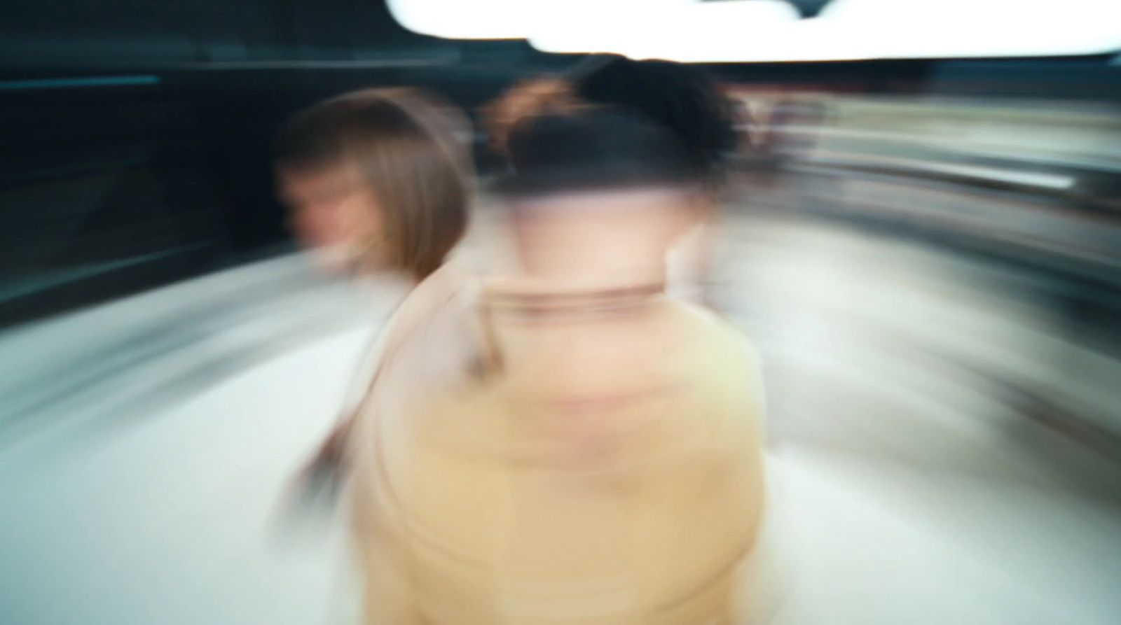 a blurry photo of two women walking down a street