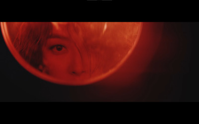 a woman's face is seen through a mirror