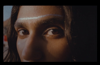 a close up of a woman's face with a strip of thread on her