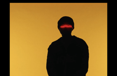 a silhouette of a man with a red light on his face