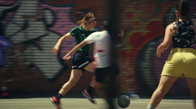 a group of young women playing a game of soccer