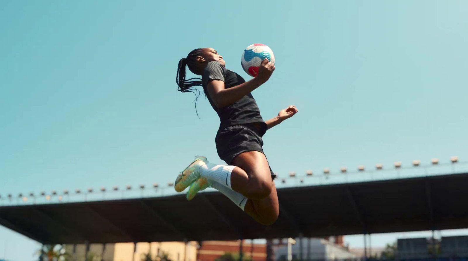 a woman jumping in the air to catch a ball