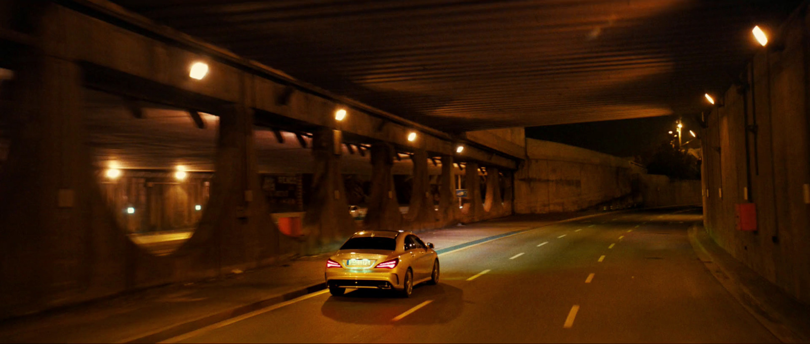 a car driving down a street at night