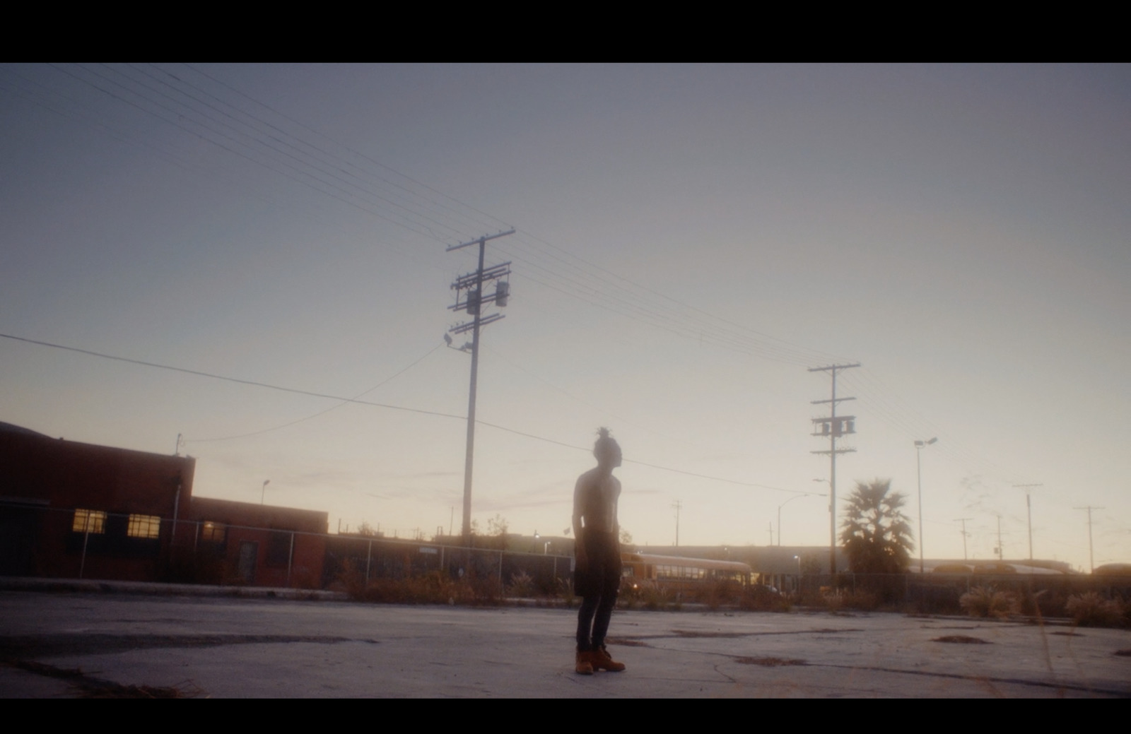 a person standing in the middle of a parking lot