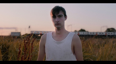 a man standing in a field of tall grass