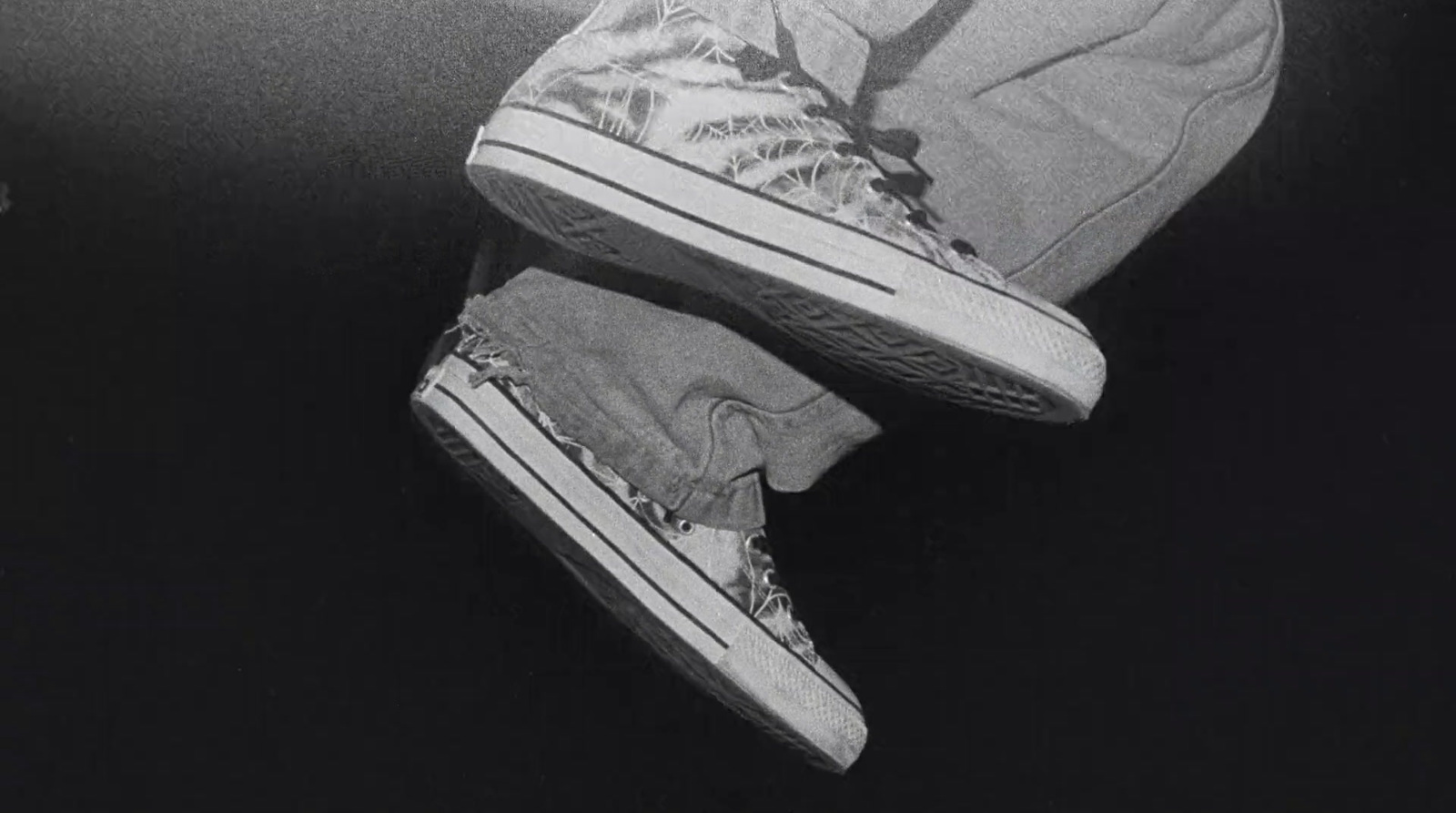 a black and white photo of a person's shoes