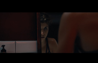 a woman looking at herself in the mirror