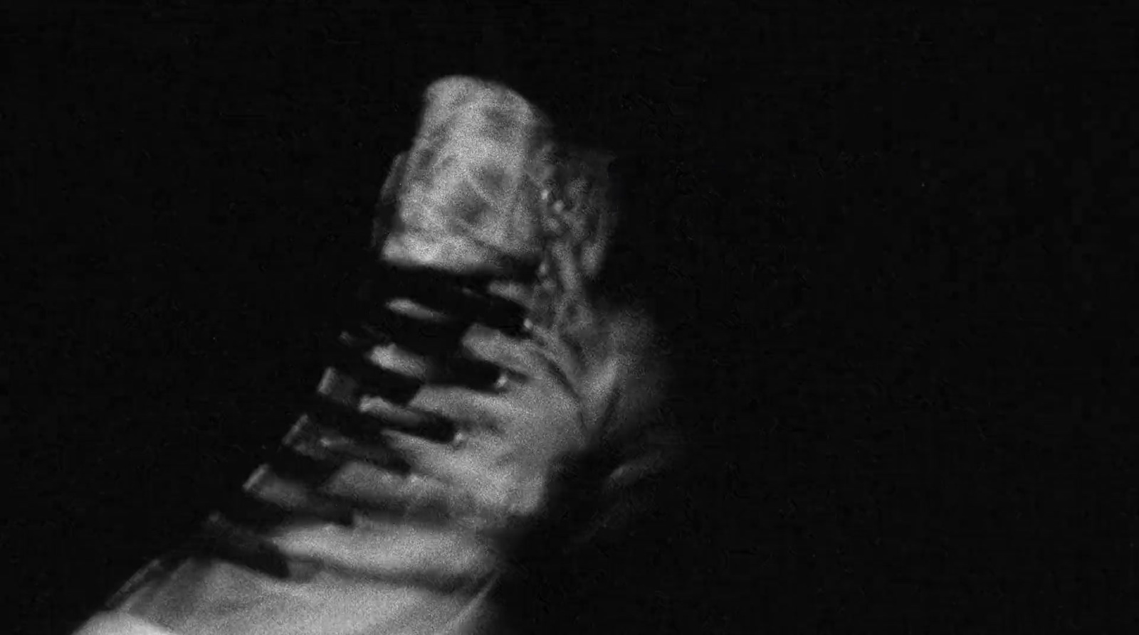 a black and white photo of a person's shoe