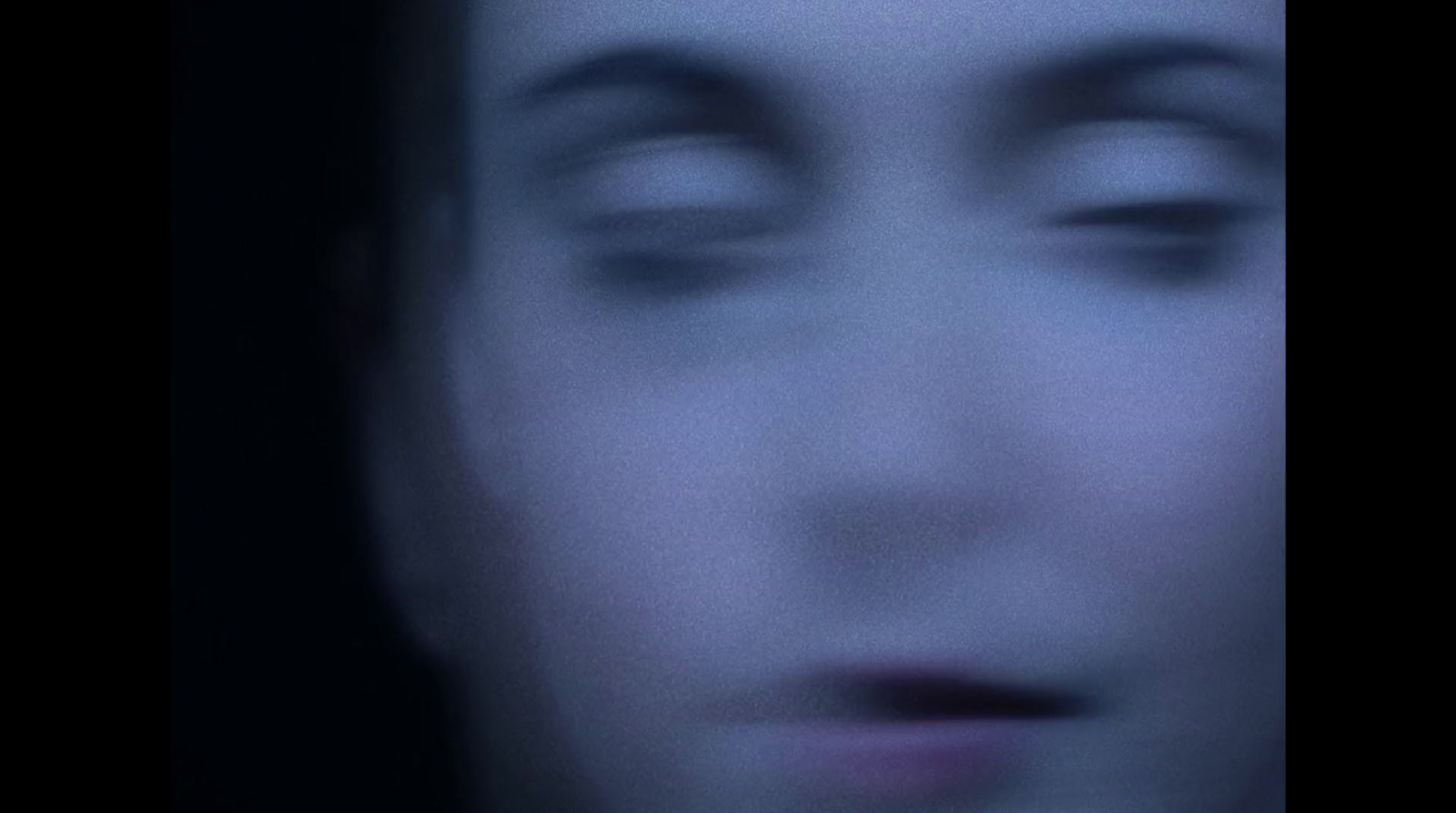 a blurry photo of a woman's face with her eyes closed