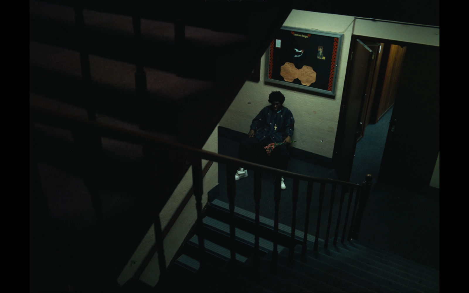 a man sitting on a stair case next to a window