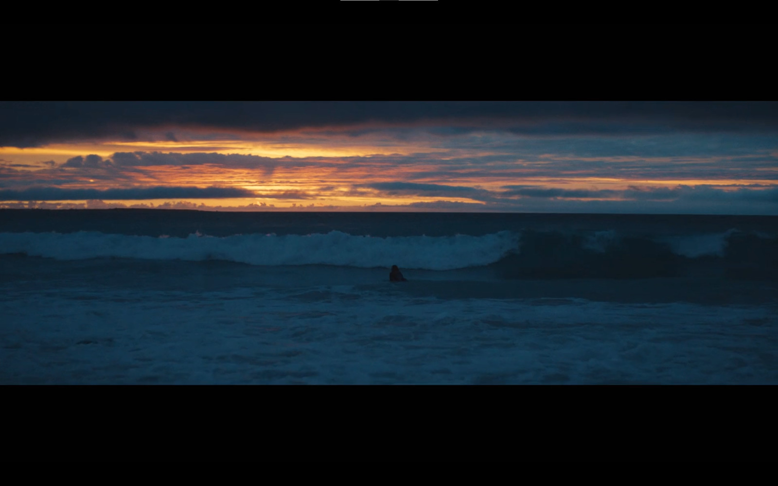 a person riding a surfboard on a wave in the ocean