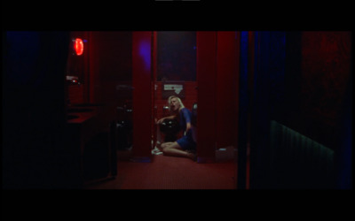 a woman sitting on the floor in a dark room