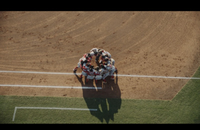 a group of people standing on top of a baseball field