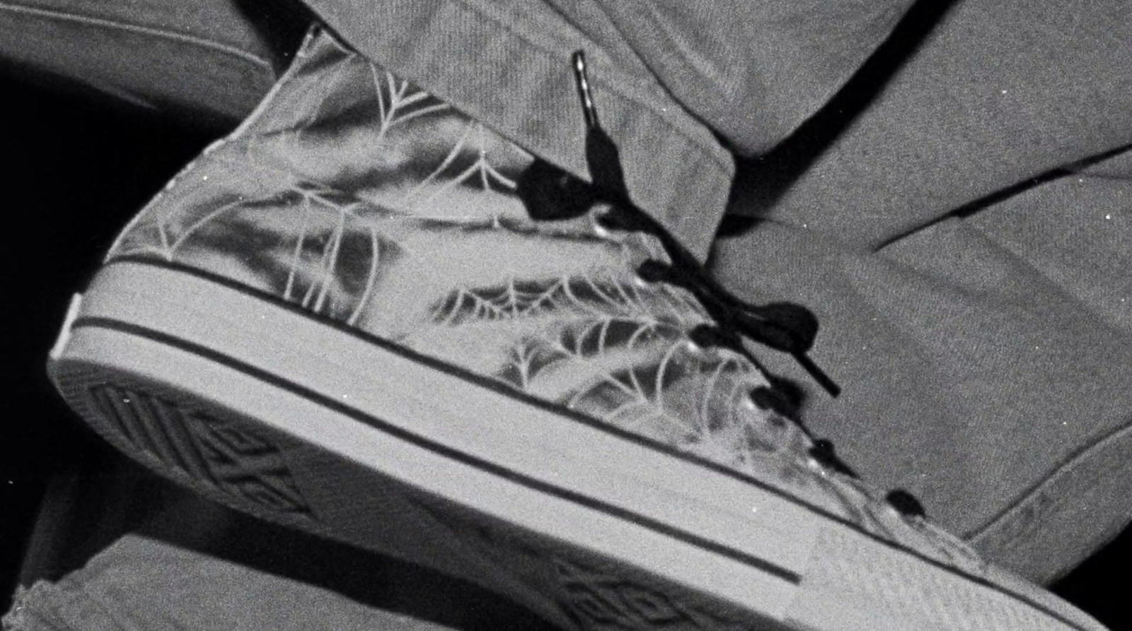 a black and white photo of someone's shoes