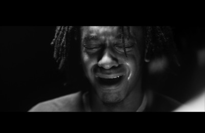 a black and white photo of a man crying