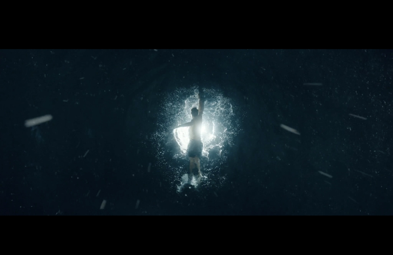 a person standing on a surfboard in the water