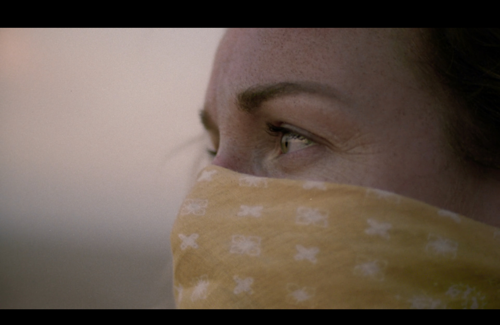 a close up of a person wearing a bandana
