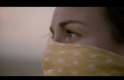a close up of a person wearing a bandana