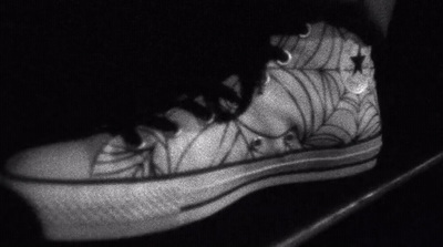 a black and white photo of a person's shoes