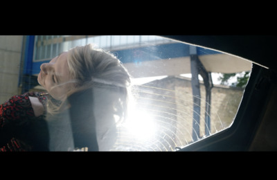 a woman looking out the window of a car