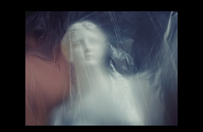 a woman standing in the rain with an umbrella