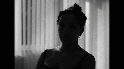 a black and white photo of a woman in a tank top