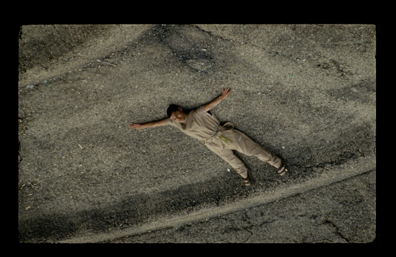 a person laying on the ground with their arms spread out