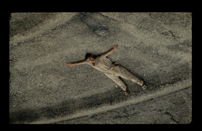 a person laying on the ground with their arms spread out