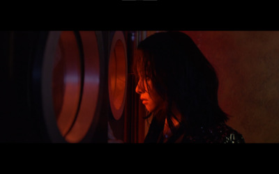 a woman standing in front of a wine rack