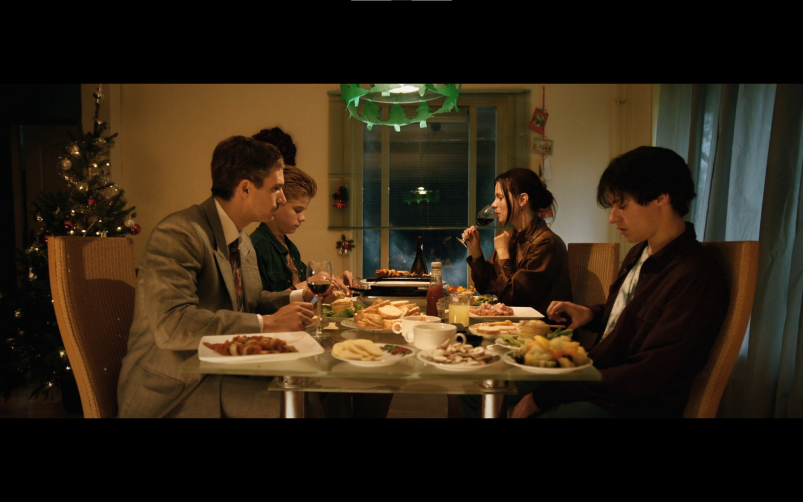 a group of people sitting around a table eating food