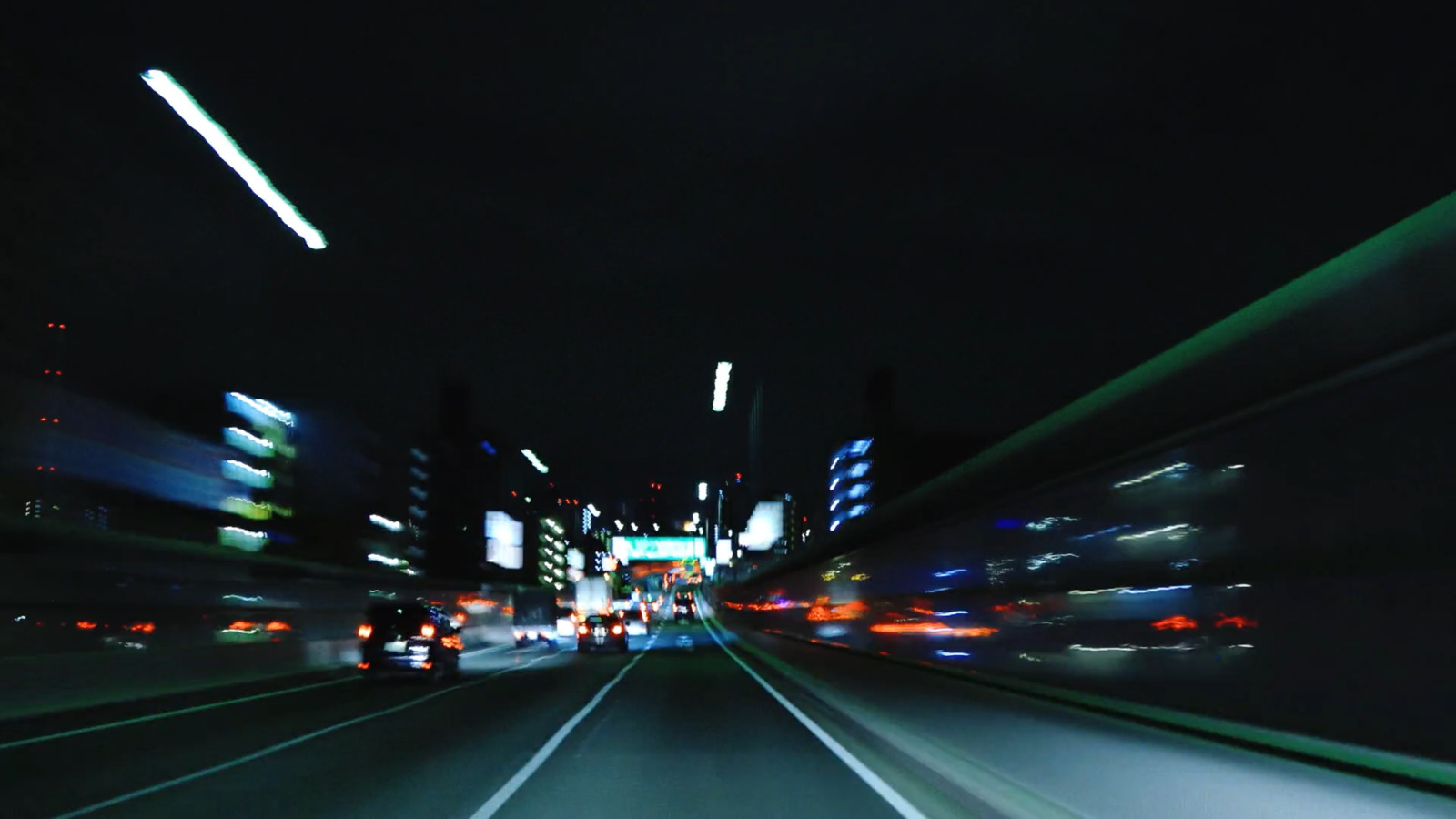 a blurry photo of a city street at night