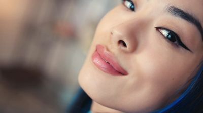 a close up of a woman with blue hair