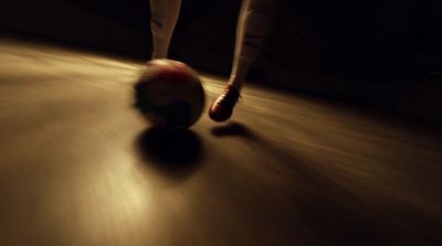 a close up of a person kicking a soccer ball