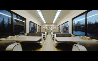 a train car with a long table and chairs