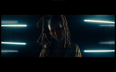 a woman with dreadlocks standing in a dark room