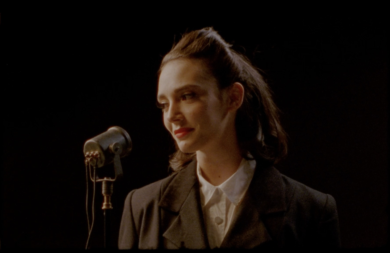 a woman standing in front of a microphone