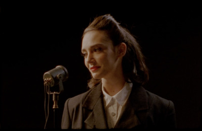 a woman standing in front of a microphone