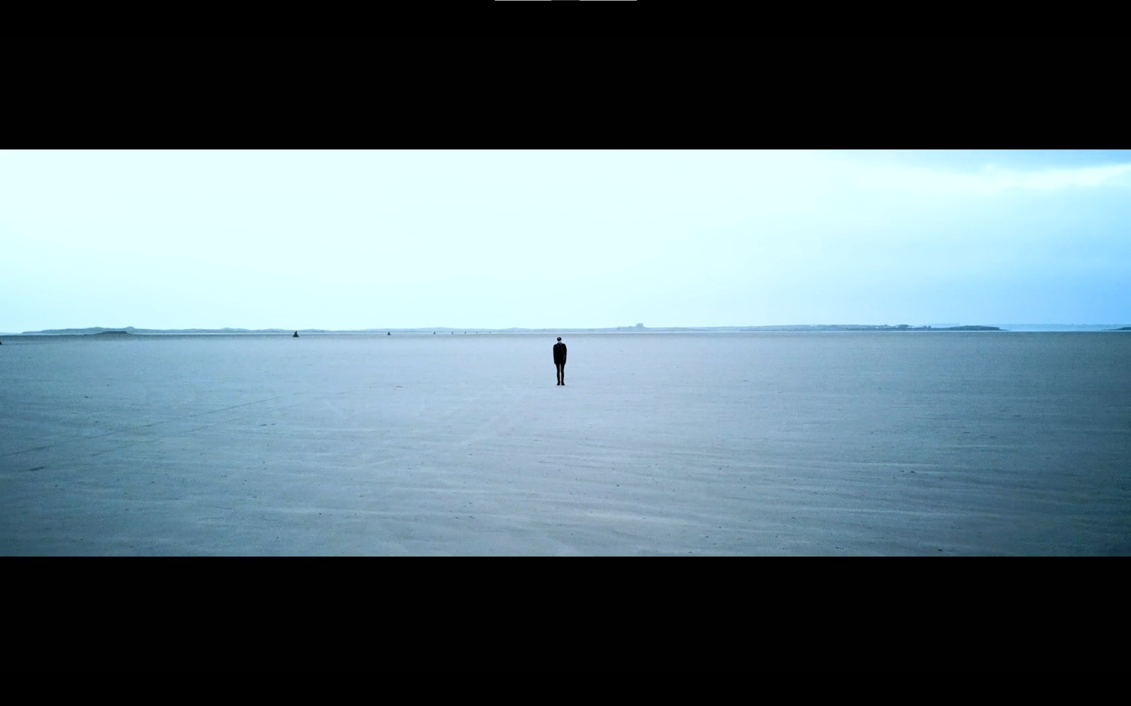 a person standing in the middle of a large body of water